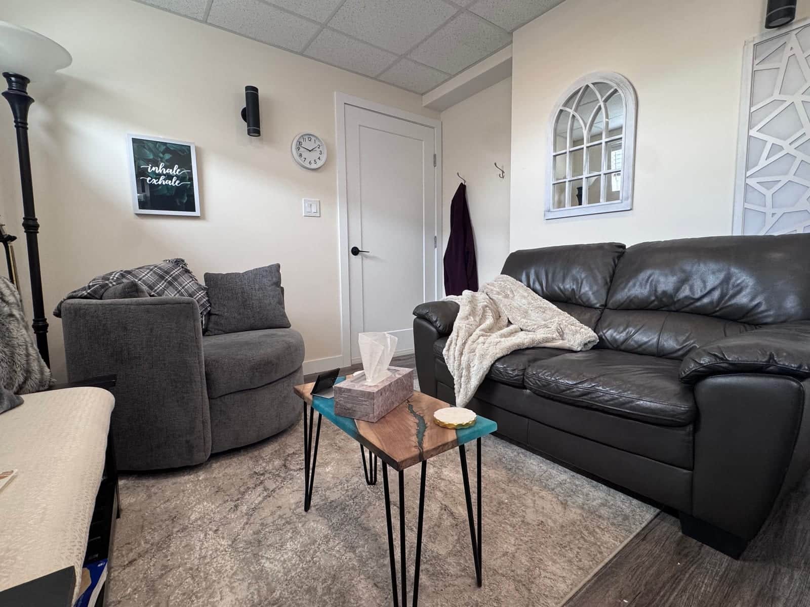 Counselling room with seating and warm lighting at The Cottage on Dawson